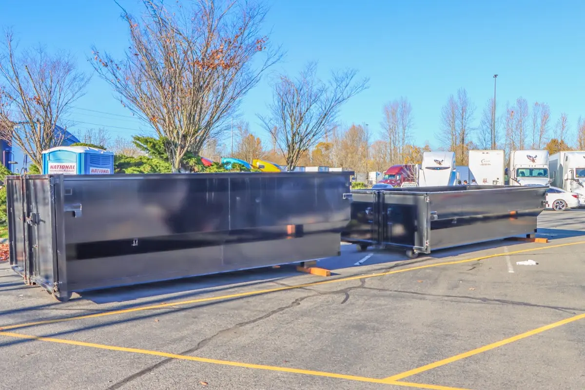 Professional dumpster rental service with roll-off container on residential driveway in Gouverneur